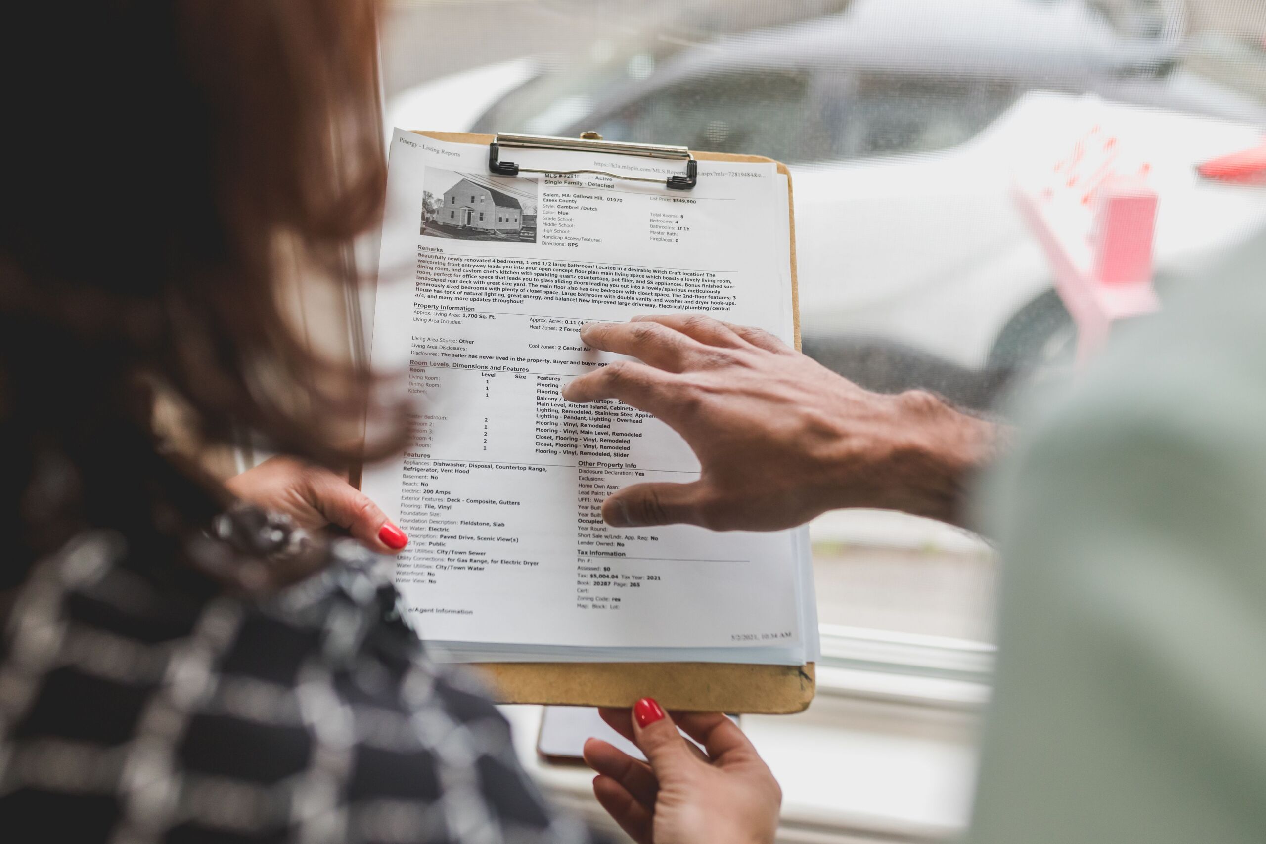 a person holding a document on a clipboard