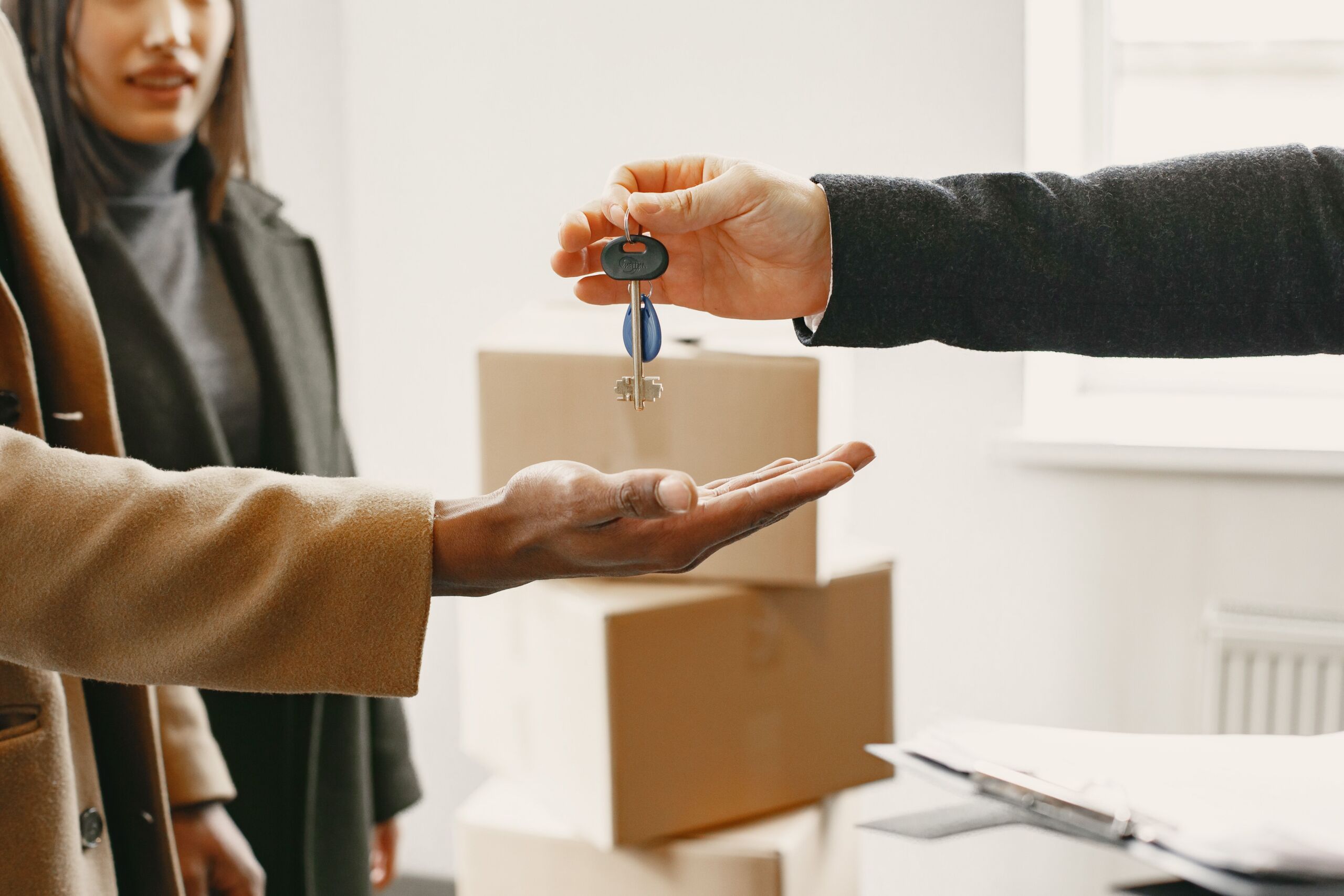 a person giving keys from new home to family